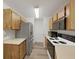 Galley kitchen with stainless steel refrigerator and wooden cabinets at 3964 Dream Oak Pl # 203, Tampa, FL 33613