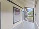 Screened porch featuring a window, door, and neutral color scheme at 3964 Dream Oak Pl # 203, Tampa, FL 33613