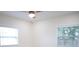 Bright bedroom with neutral walls, two windows and a ceiling fan at 4720 Murray Hill Dr, Tampa, FL 33615