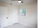 Bright bedroom with white walls, new floors, ceiling fan, closet and natural light from window at 4720 Murray Hill Dr, Tampa, FL 33615