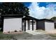 Stylish single-story house featuring a gray exterior, tidy landscaping, and a modern entrance at 4720 Murray Hill Dr, Tampa, FL 33615