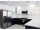 Bright kitchen featuring stainless steel appliances, two-tone cabinets, and white countertops at 4720 Murray Hill Dr, Tampa, FL 33615