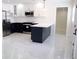 Modern kitchen with stainless steel appliances, two-tone cabinets, and marble floors at 4720 Murray Hill Dr, Tampa, FL 33615