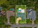 A high-definition aerial view of the property shows its pool and proximity to other homes in the neighborhood at 5110 Lake Valencia E Blvd, Palm Harbor, FL 34684