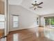 Bright bedroom with hardwood floors and a sliding glass door to the backyard at 5110 Lake Valencia E Blvd, Palm Harbor, FL 34684