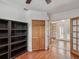 Bedroom showcasing built-in shelving and closet space with french doors at 5110 Lake Valencia E Blvd, Palm Harbor, FL 34684
