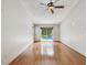Spacious bedroom with hardwood floors and sliding glass doors that lead to a pool area at 5110 Lake Valencia E Blvd, Palm Harbor, FL 34684