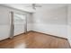 Bedroom featuring hardwood floors, white walls, and a window with curtain at 5110 Lake Valencia E Blvd, Palm Harbor, FL 34684