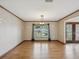 Bright dining room features hardwood floors and a large window with backyard views at 5110 Lake Valencia E Blvd, Palm Harbor, FL 34684
