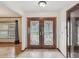 Inviting foyer with double doors featuring decorative glass and tile flooring creating a bright, open entrance at 5110 Lake Valencia E Blvd, Palm Harbor, FL 34684