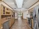 Large kitchen featuring stainless steel appliances, tile countertops, and a bright skylight at 5110 Lake Valencia E Blvd, Palm Harbor, FL 34684