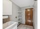 Laundry room with tiled floors, wire shelving, and a deep sink at 5110 Lake Valencia E Blvd, Palm Harbor, FL 34684