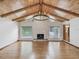 An open living room showcasing a vaulted ceiling with wood paneling and an inviting fireplace at 5110 Lake Valencia E Blvd, Palm Harbor, FL 34684