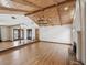 Spacious living room featuring hardwood floors, wooden ceiling, and a stone fireplace at 5110 Lake Valencia E Blvd, Palm Harbor, FL 34684