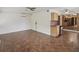Living room with tile flooring and partial view of the kitchen and back door at 5110 Lake Valencia E Blvd, Palm Harbor, FL 34684