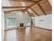 A spacious living room featuring wood floors, a fireplace, and a vaulted ceiling with wood paneling and a chandelier at 5110 Lake Valencia E Blvd, Palm Harbor, FL 34684