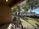Large backyard with mature trees, grass, white fence, and covered patio, ideal for outdoor living at 8819 Walnut Gable Ct, Riverview, FL 33578