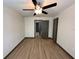 A bright bedroom featuring hardwood flooring and a modern ceiling fan at 8819 Walnut Gable Ct, Riverview, FL 33578