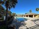 Inviting community pool area with lounge chairs and a covered pavilion for relaxation and enjoyment at 8819 Walnut Gable Ct, Riverview, FL 33578