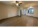Spacious living area with neutral walls, ceiling fan and laminate floors at 8819 Walnut Gable Ct, Riverview, FL 33578