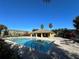 Community pool featuring crystal blue water, sun loungers, covered area, and well-manicured landscaping at 8819 Walnut Gable Ct, Riverview, FL 33578