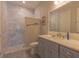 Bright bathroom features a walk-in shower with marble surround and modern vanity at 9016 Falcon Ct, Venice, FL 34293