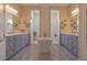Luxurious bathroom with dual vanities, a soaking tub, and separate glass-enclosed showers on either side at 9016 Falcon Ct, Venice, FL 34293