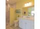 Well-lit bathroom featuring a marble walk-in shower, shelves with rolled towels, and a modern vanity at 9016 Falcon Ct, Venice, FL 34293