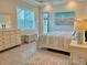 Serene bedroom with soft lighting, plush bedding, and a view of the outdoor pool area at 9016 Falcon Ct, Venice, FL 34293
