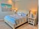 Comfortable bedroom featuring soft lighting, a cozy bed, and stylish bedside tables with lamps at 9016 Falcon Ct, Venice, FL 34293
