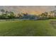 Exterior shot of a beautiful single-story home with lush landscaping and a well-manicured lawn at 9016 Falcon Ct, Venice, FL 34293