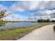 Scenic lake view with a walking path, showcasing the natural beauty and recreational opportunities within the community at 9016 Falcon Ct, Venice, FL 34293