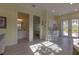 Open living area with bathroom and bedroom access, complemented by a cozy dining space at 9016 Falcon Ct, Venice, FL 34293