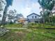 Expansive backyard boasts outbuildings, a garden, and a relaxing outdoor entertainment space at 10928 Echo Loop, New Port Richey, FL 34654