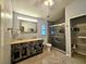 Modern bathroom with a double vanity, shower, and linen closet at 10928 Echo Loop, New Port Richey, FL 34654