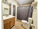 Cozy bathroom with a wooden vanity and a tiled shower at 10928 Echo Loop, New Port Richey, FL 34654