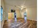 Spacious bedroom with wood floors, large windows, a vaulted ceiling, and access to a walk-in closet at 10928 Echo Loop, New Port Richey, FL 34654