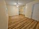 Sunny bedroom with wood floors, a ceiling fan, large windows, and a closet at 10928 Echo Loop, New Port Richey, FL 34654
