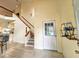Inviting foyer with tile floors, staircase, and a bright front door, leading to an open-concept living space at 10928 Echo Loop, New Port Richey, FL 34654