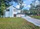 Inviting two-story home with stone accents, well-manicured lawn, and a paved driveway at 10928 Echo Loop, New Port Richey, FL 34654