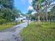 Charming two-story home with black iron fence, lush landscaping, and a long drive at 10928 Echo Loop, New Port Richey, FL 34654