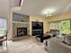Inviting living room featuring a stone fireplace, tile floors, and a comfortable seating area at 10928 Echo Loop, New Port Richey, FL 34654