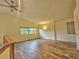 Spacious loft features wood floors, a vaulted ceiling, a ceiling fan, and large windows at 10928 Echo Loop, New Port Richey, FL 34654