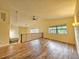 Open loft area with wood flooring, a vaulted ceiling, and natural light streaming through multiple windows at 10928 Echo Loop, New Port Richey, FL 34654