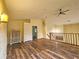 Bright loft area featuring wood floors, a vaulted ceiling, storage, and views of the home's staircase at 10928 Echo Loop, New Port Richey, FL 34654