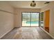 Enclosed sunroom with tile flooring overlooking the inviting screened-in pool area and lush greenery at 10928 Echo Loop, New Port Richey, FL 34654