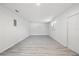 Spacious basement area with vinyl floors, white walls, and natural light from a window at 4410 Lurline Cir, Tampa, FL 33610