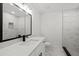 Modern bathroom featuring a sleek vanity, walk-in shower with marble tiling at 4410 Lurline Cir, Tampa, FL 33610
