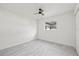 Well-lit bedroom featuring light grey flooring, a ceiling fan, and a window at 4410 Lurline Cir, Tampa, FL 33610