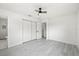 This bedroom features gray wood-look floors, ceiling fan and a closet at 4410 Lurline Cir, Tampa, FL 33610